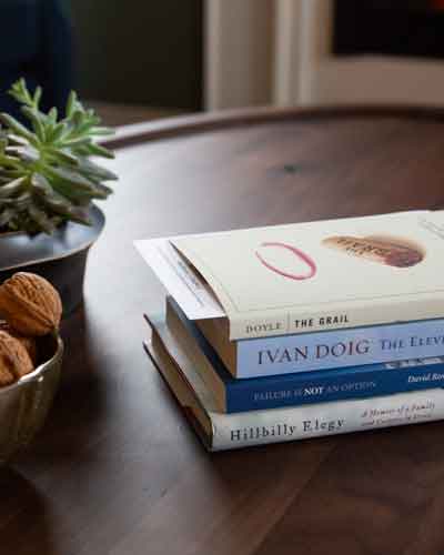 A stack of books selected for a room at the Atticus Hotel in McMinnville, Oregon